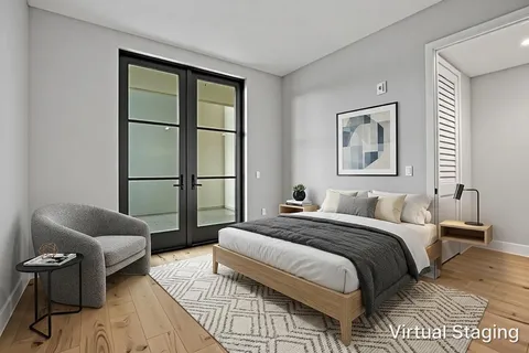 a bedroom with a bed couch and a window
