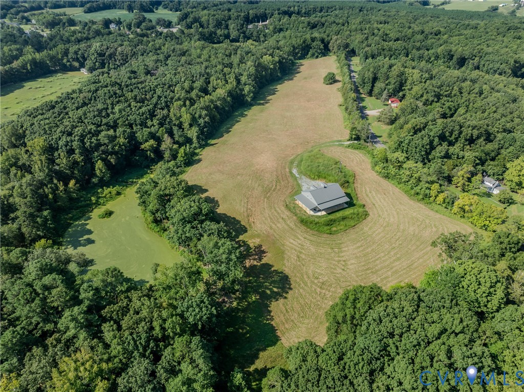 an aerial view of a house with a yard and lake view