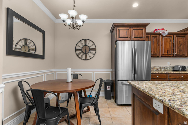 476 West 200 N Street, Unit 206 Springville, UT 84663 - Photo 5 of 24 Dining room with hanging lights, crown molding, wainscoting, a decorative wall, and light tile patterned floors