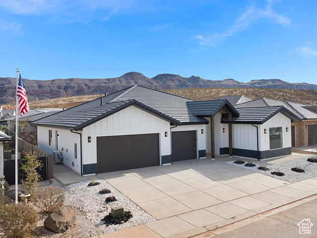 3145 Snow Cyn Road Hurricane, UT 84737 - Photo 31 of 38 Modern inspired farmhouse with board and batten siding, an attached garage, a mountain view, concrete driveway, and a tiled roof