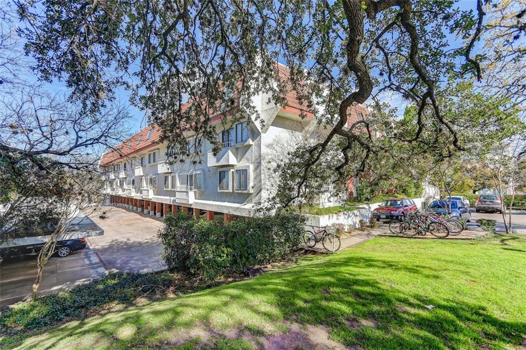 3115 Helms Street, Unit 204 Austin, TX 78705 - Photo 13 of 13 A classic multi-level residential building offers ample parking amidst mature shade trees.