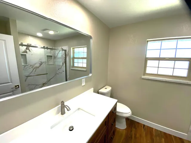 a bathroom with a shower and a sink