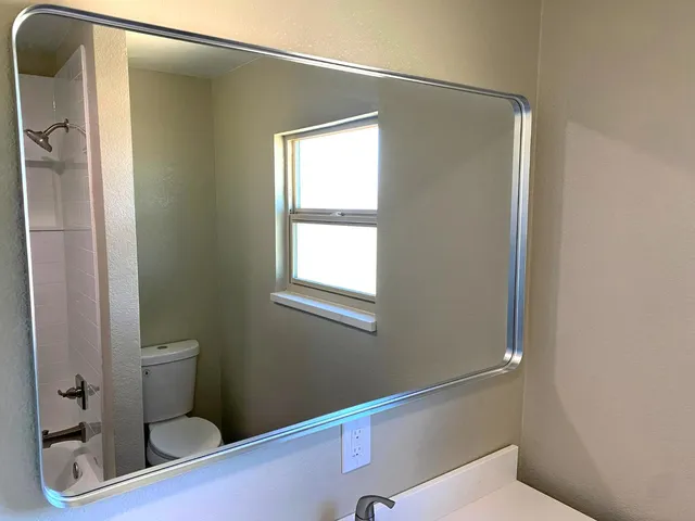 a bathroom with a toilet and shower