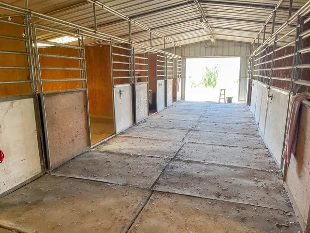 a view of a garage with wooden fence