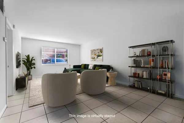 a living room with furniture and a book shelf