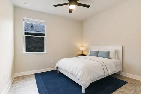a bedroom with a large bed and a window