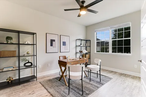 a workspace with furniture window and wooden floor