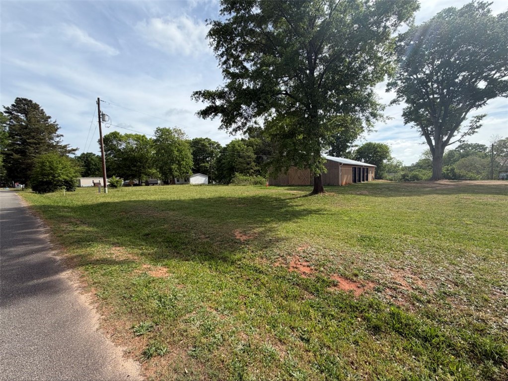 102 Sioux Street Laurens, SC 29360 - Photo 7 of 8 This spacious lot offers ample room for your vision, complete with an expansive barn and mature trees.