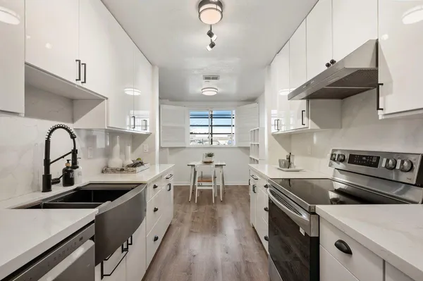 a kitchen with lots of counter top space and stove