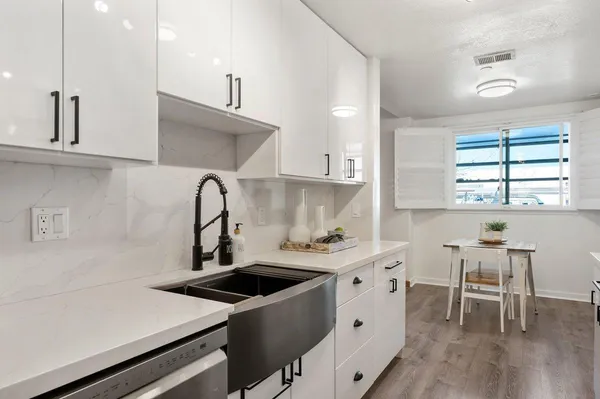 a kitchen with a sink cabinets and window