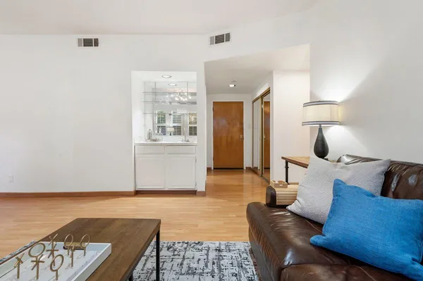 a living room with furniture and wooden floor