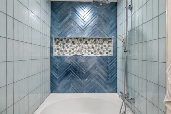 a bathroom with a bathtub and shower