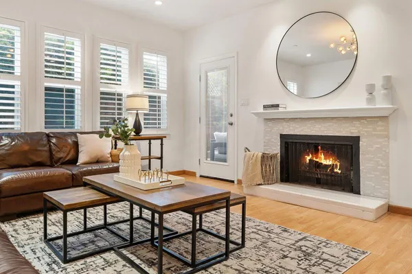 a living room with a fireplace a rug and a fireplace