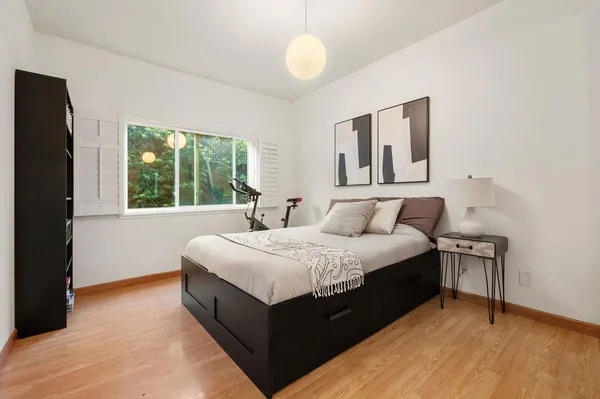 a spacious bedroom with a bed and window