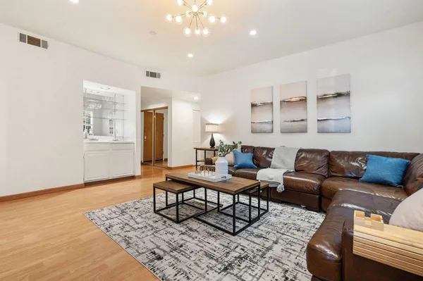 a living room with furniture and wooden floor