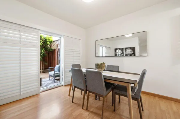 a view of a dining room with furniture and wooden floor