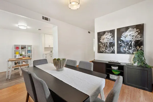 a view of a dining room with furniture and wooden floor