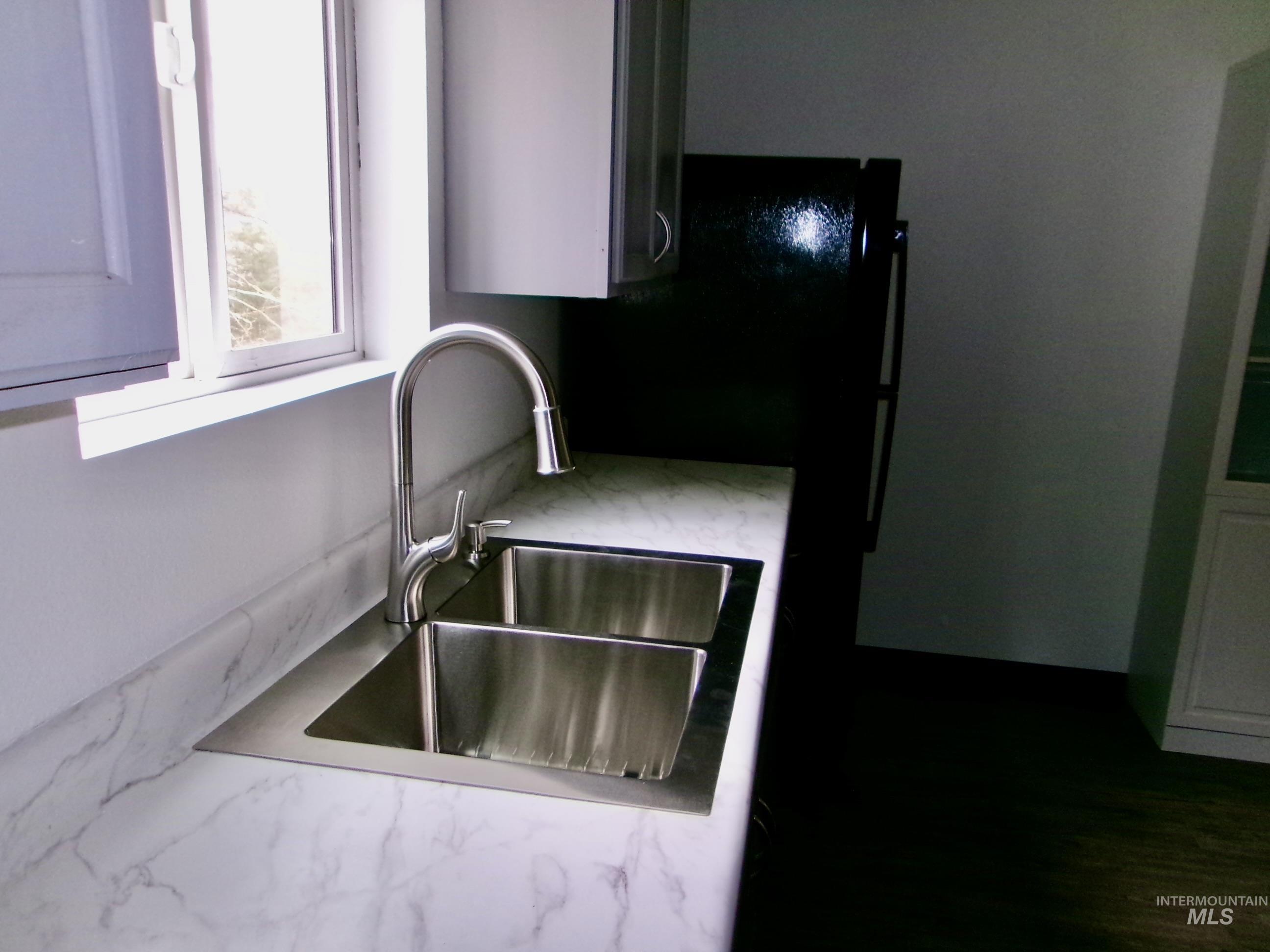 123 Conifer Lane Stites, ID 83552 - Photo 16 of 48 Kitchen view of light stone countertops and freestanding refrigerator