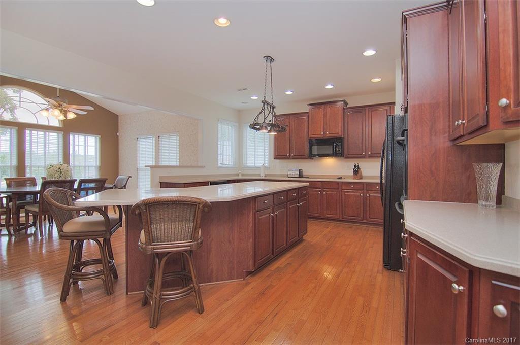 221 Choate Avenue Fort Mill, SC 29708 - Photo 6 of 24 a kitchen with stainless steel appliances kitchen island granite countertop a table chairs sink and cabinets