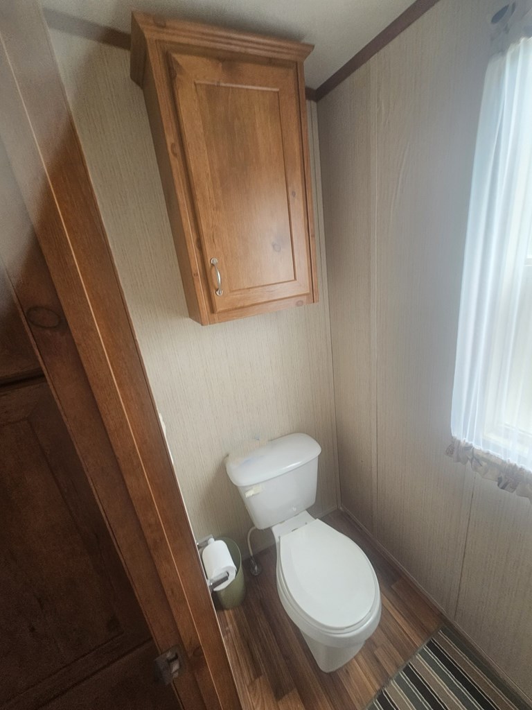 1862 Sd 31846 Rocksprings, TX 78880 - Photo 30 of 32 a white toilet sitting next to a small window