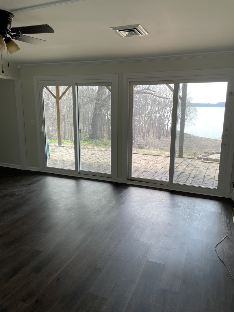 3512 Riverview Lake Road Metropolis, IL 62960 - Photo 5 of 20 an empty room with wooden floor and windows
