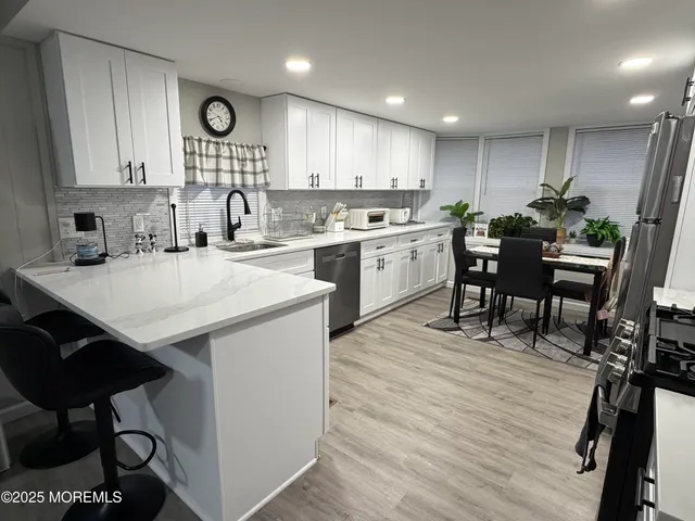 a kitchen with a table chairs stove and cabinets