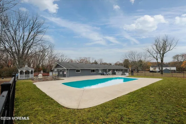 a view of a swimming pool with a yard
