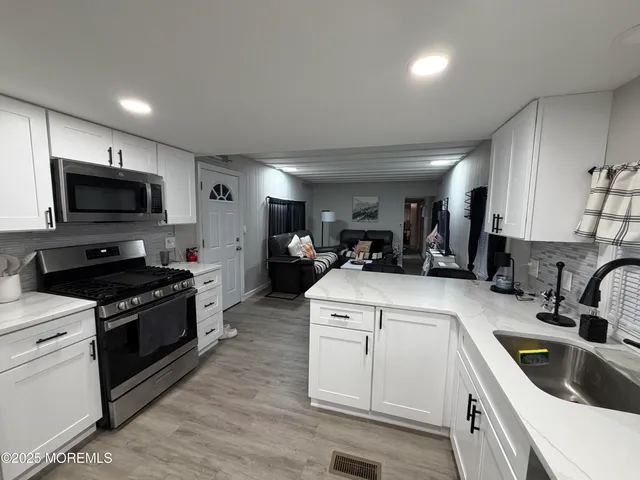 a kitchen that has a sink and a stove in it
