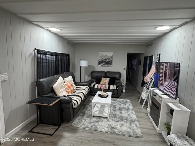 a living room with furniture fireplace and a flat screen tv