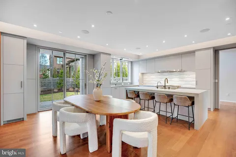 a kitchen with stainless steel appliances a sink stove and wooden floor