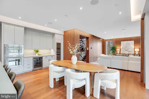 a kitchen with a sink a microwave and cabinets