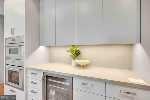 a kitchen with a sink window and cabinets