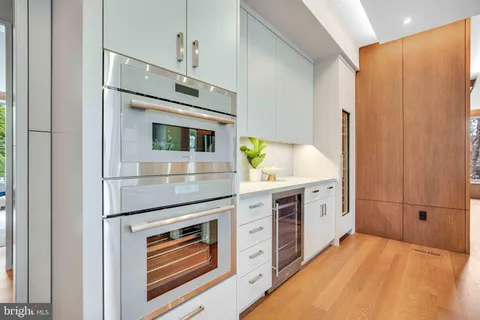 a kitchen with stainless steel appliances a sink stove and cabinets