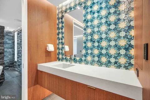 a view of an empty room with wooden floor and window