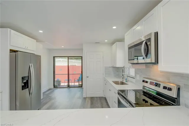 a view of kitchen with cabinets and wooden floor