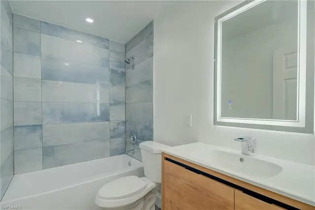 a bathroom with a sink toilet and bathtub