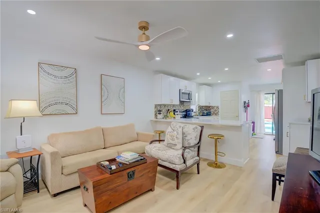 a living room with furniture and kitchen view