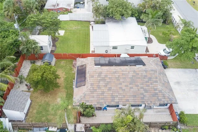an aerial view of a house with a yard