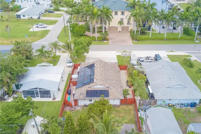 an aerial view of a house with a garden and swimming pool