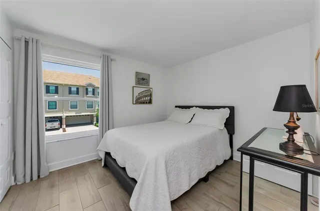 a large bed sitting in a bedroom next to a window