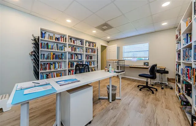 a view of a workspace with furniture and a bookshelf