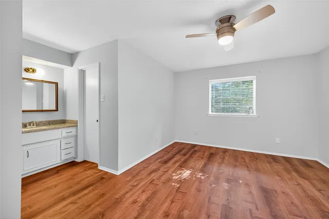a view of a bedroom with cabinet and windows