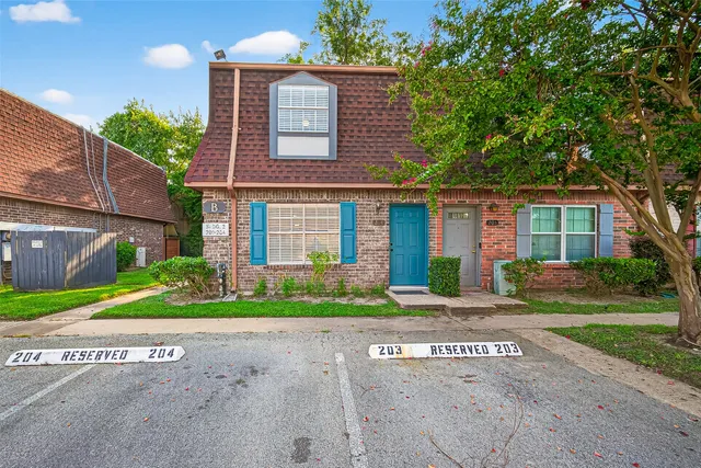 a front view of a house with a yard and a garage