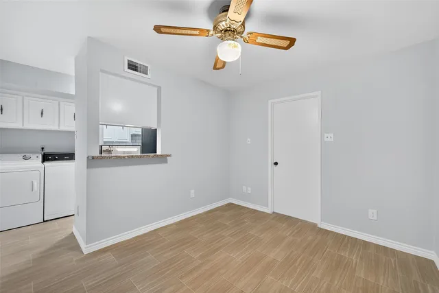 a view of kitchen with wooden floor electronic appliances and window