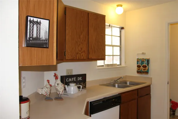 a kitchen with a sink cabinets and window