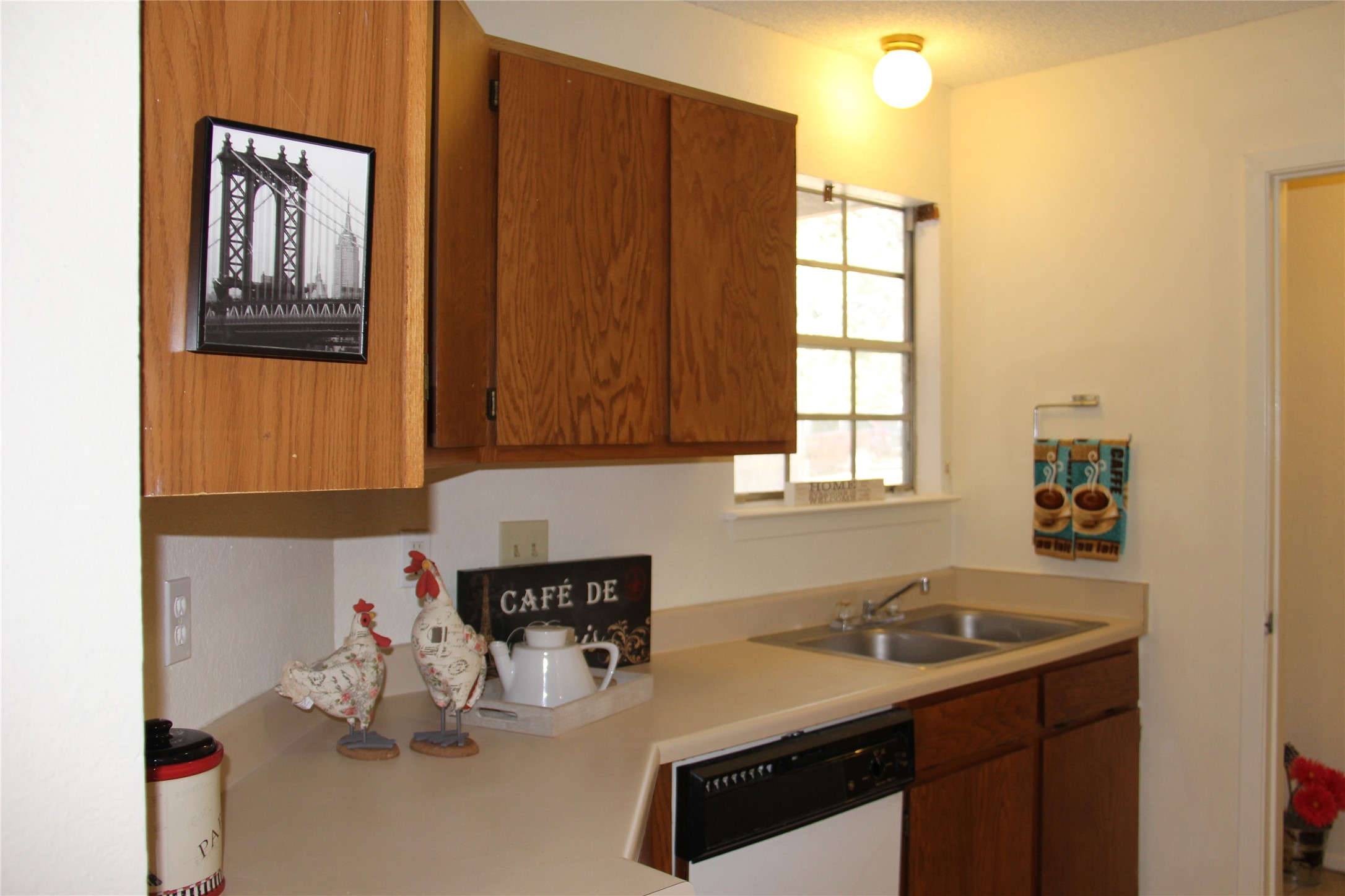 11611 Rustic Rock Drive, Unit B Austin, TX 78750 - Photo 12 of 25 a kitchen with a sink cabinets and window