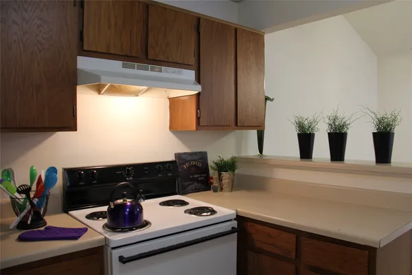 a kitchen with a stove and cabinets