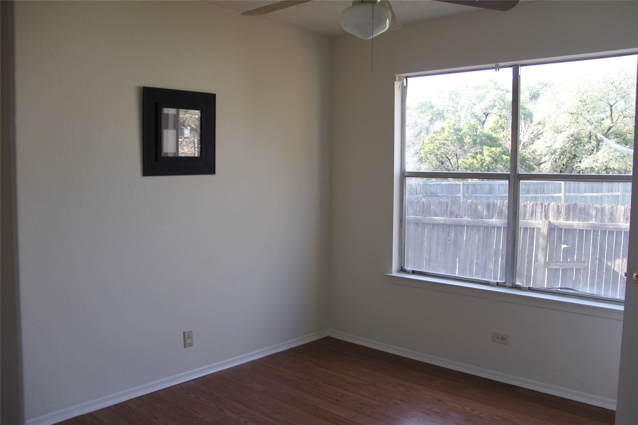 11611 Rustic Rock Drive, Unit B Austin, TX 78750 - Photo 14 of 25 an empty room with wooden floor and windows