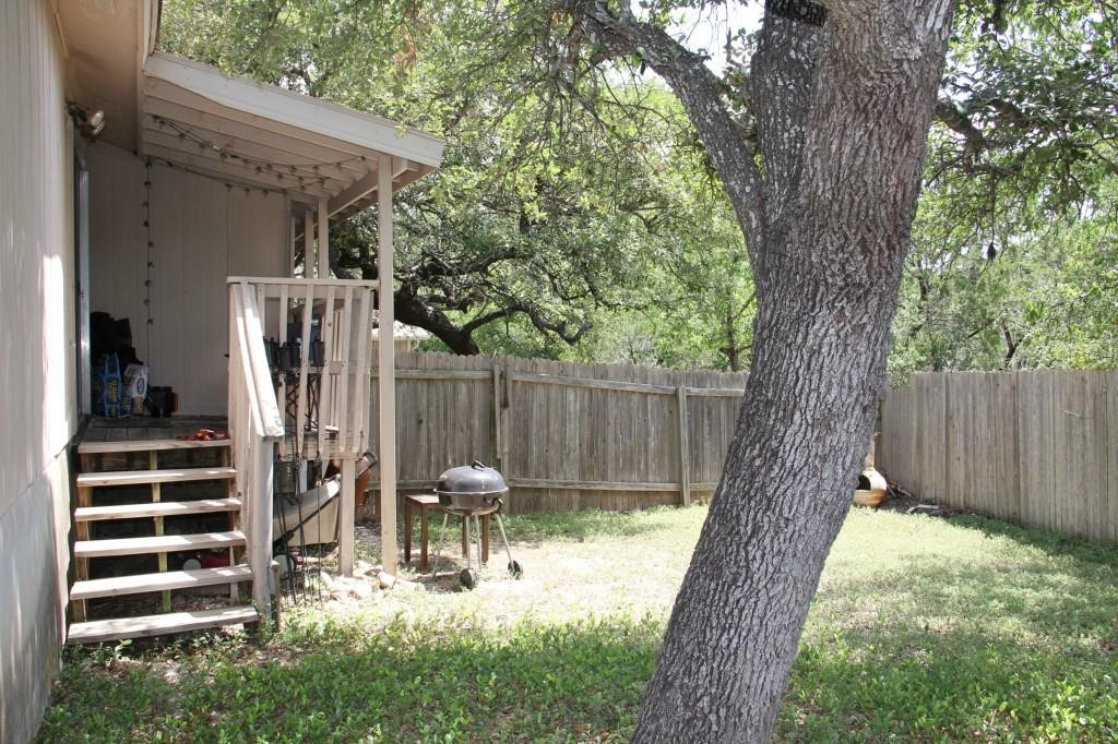 11611 Rustic Rock Drive, Unit B Austin, TX 78750 - Photo 23 of 25 a view of a patio with table and chairs and a large tree