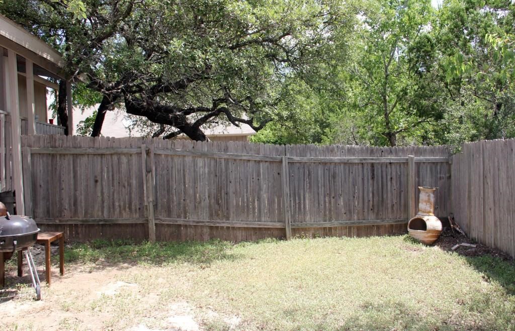 11611 Rustic Rock Drive, Unit B Austin, TX 78750 - Photo 25 of 25 a backyard of a house with lawn chairs and wooden fence